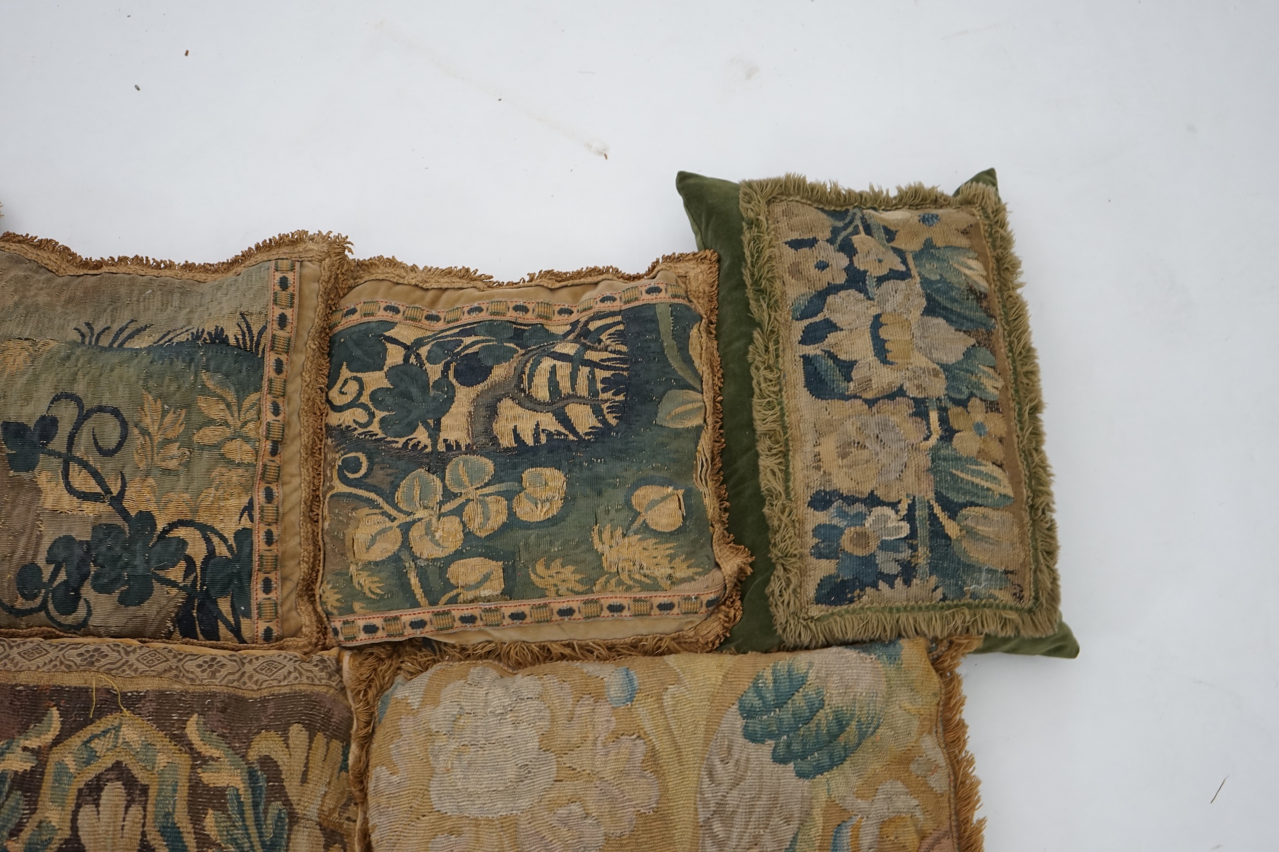 A four pairs of tapestry cushions and a similar single cushion